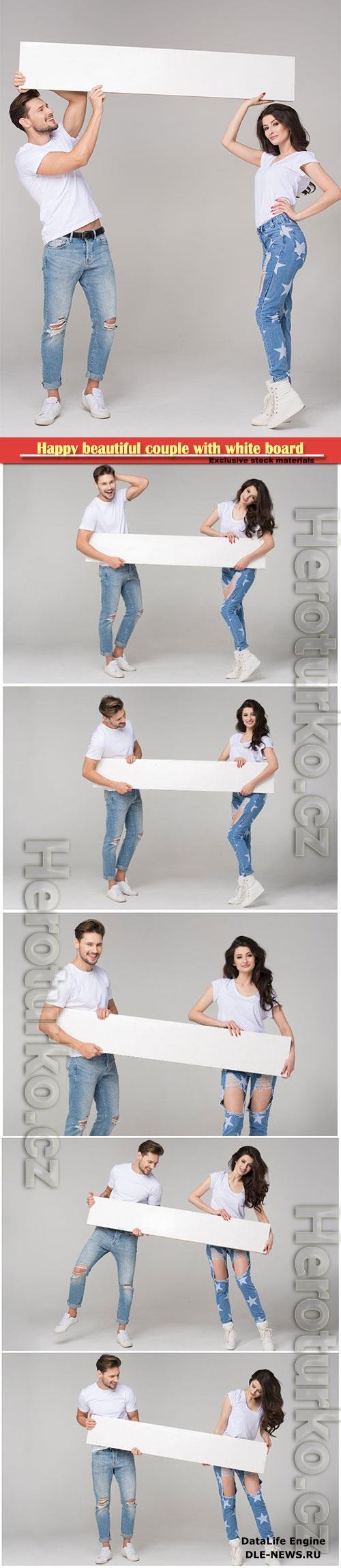 Young couple in jeans hold a white poster