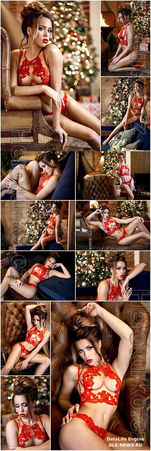 Girl in red lingerie on the background of a christmas tree stock photo